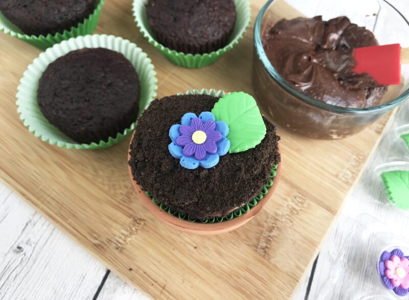 Adding the flower and leaf decor on the top of the cupcakes 