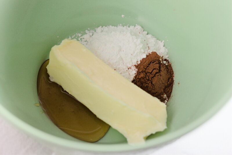 Powdered sugar, cinnamon and honey in medium mixing bowl