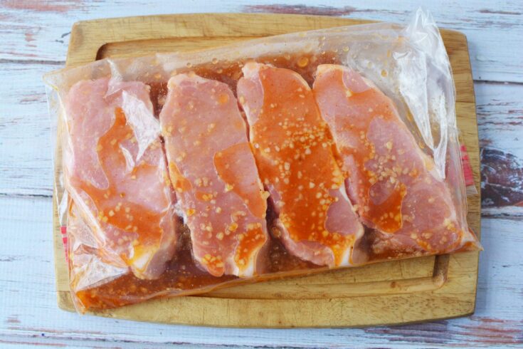 Center cut pork chops in freezer bag with marinade.