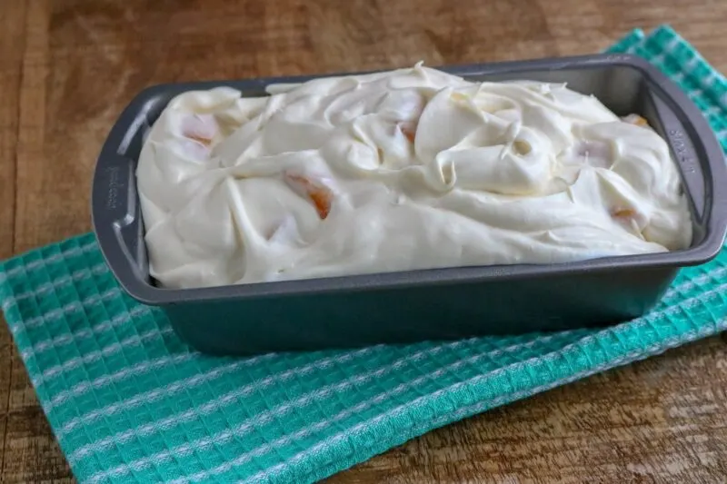 Peach Ice Cream in freezer container ready to serve