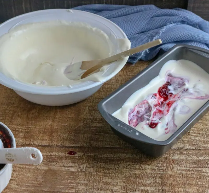 Pouring half of the ice cream mixture into the bowl