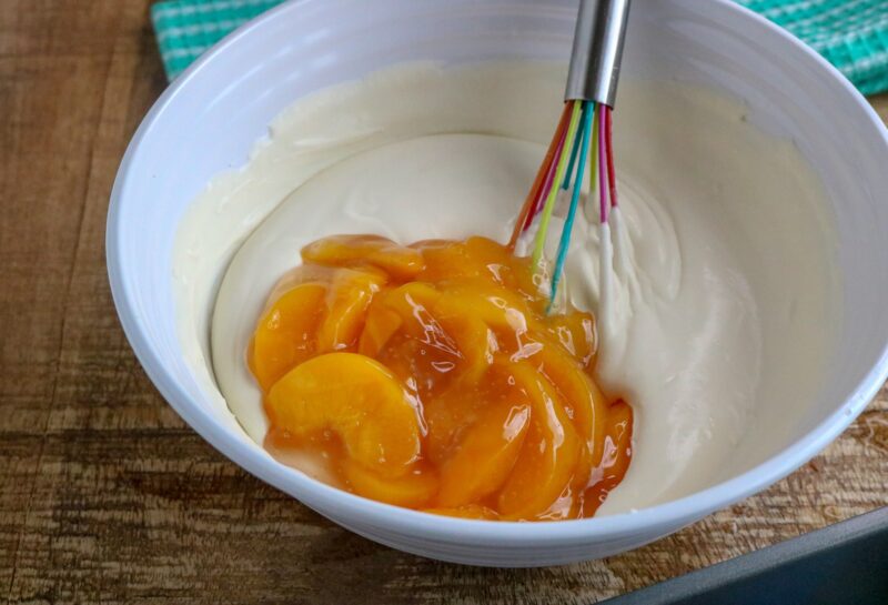 adding peaches to the ice cream mixture