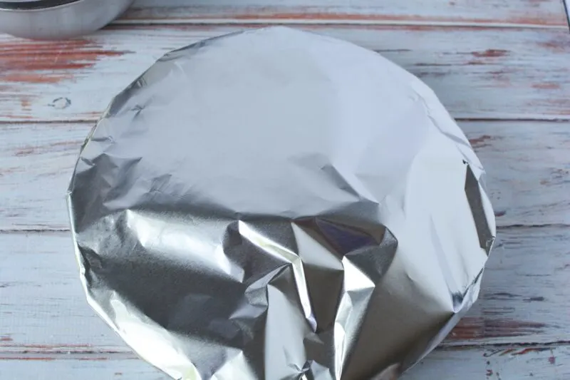 Covering pie with aluminum foil to bake