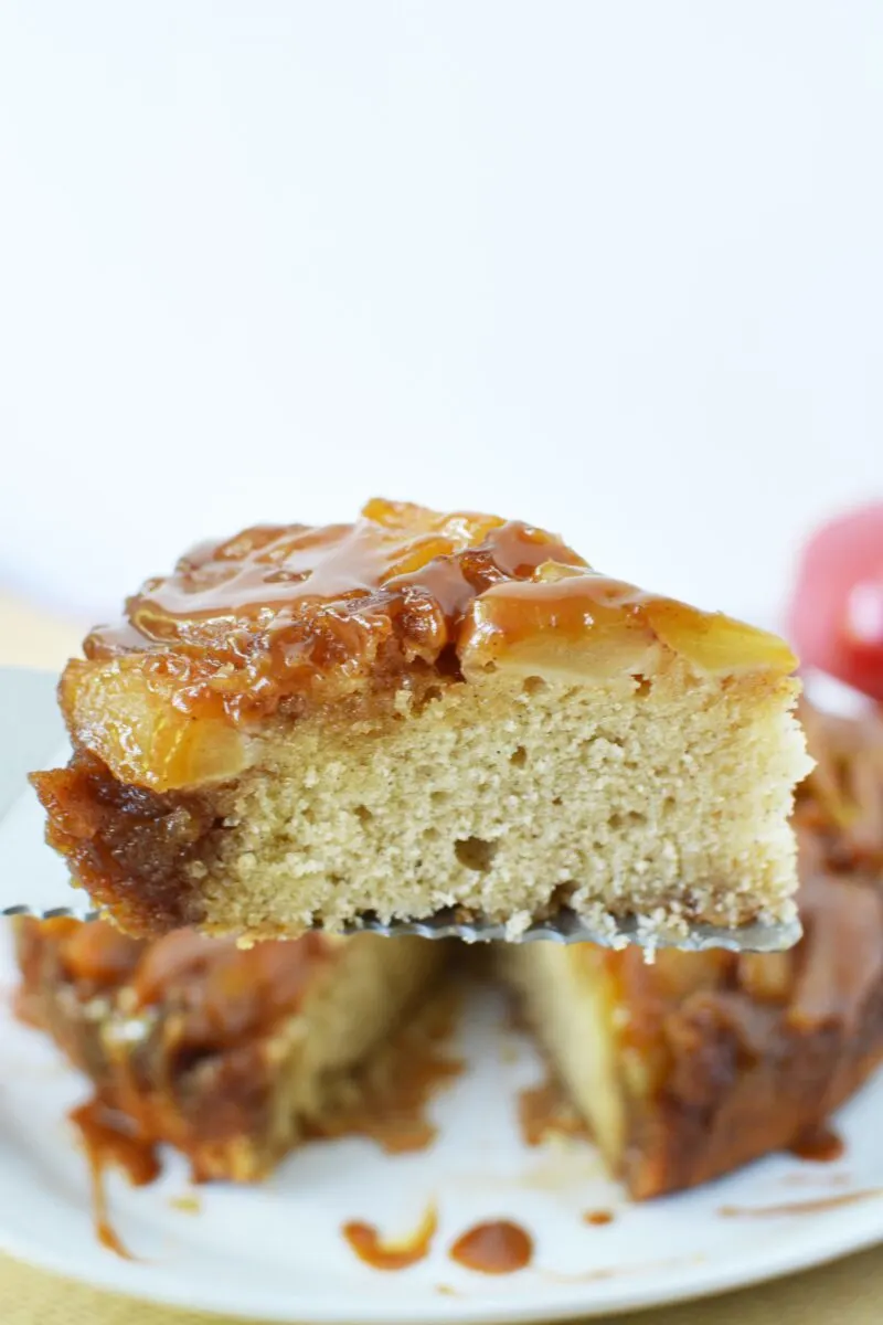 Serving of the cake with apple on top