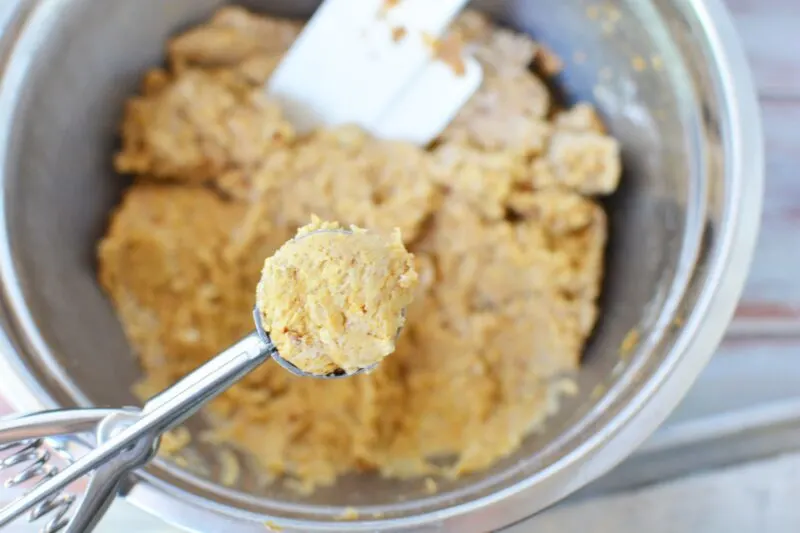 Scooping out the Pumpkin snowball cookie dough