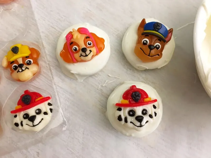 Putting the Paw Patrol decoration on top of the cookie