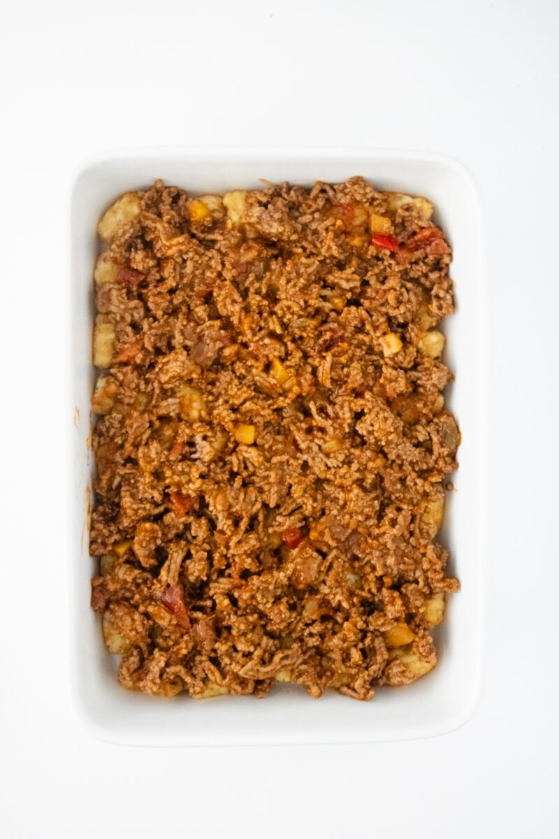 Ground beef mixture on top of tater tot layer.