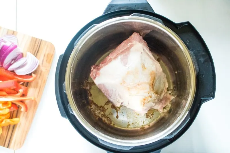 Saute the pork shoulder until seared on both sides