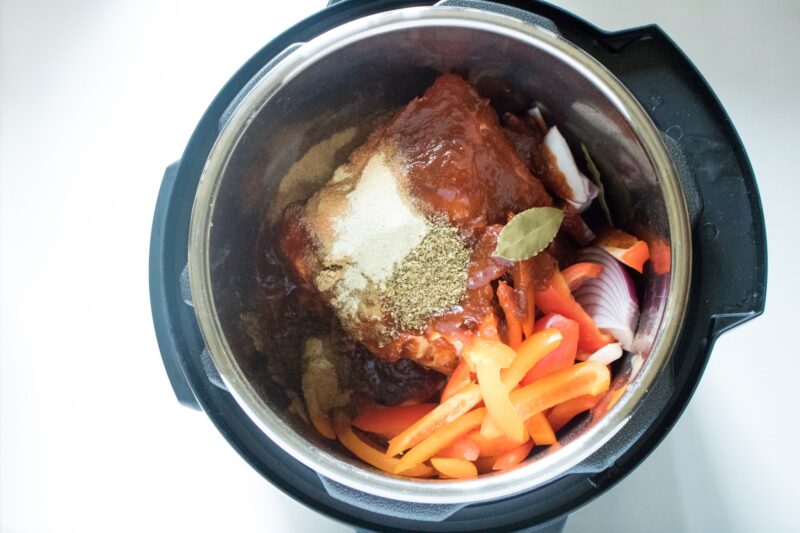 Adding the spices and vegetables to the Instant Pot