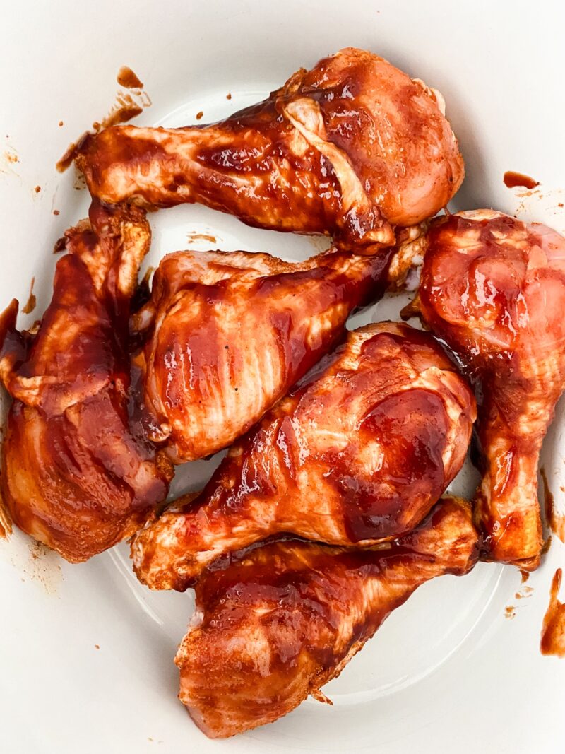 Brushing the BBQ sauce onto the chicken