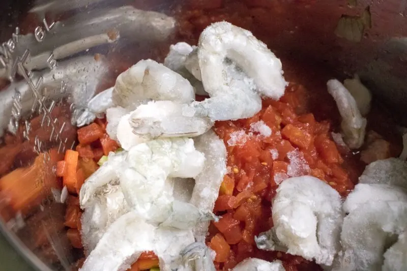 Adding shrimp to cook in the Gumbo
