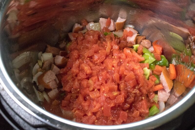 Adding the sausage, peppers and tomato