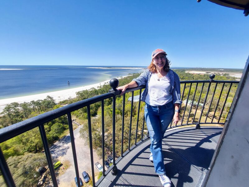 Woman standing at the top of the Pensacola Lighthouse. Things to see in Pensacola Florida
