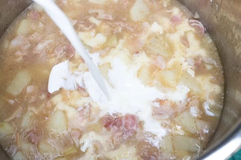Adding the half-and-half into the soup.
