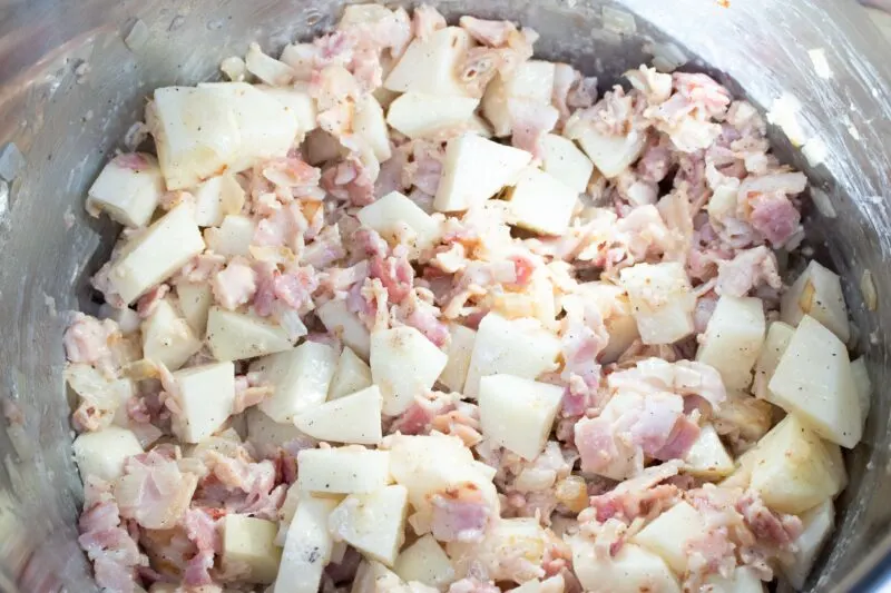 Toss the potatoes into the clams and bacon.