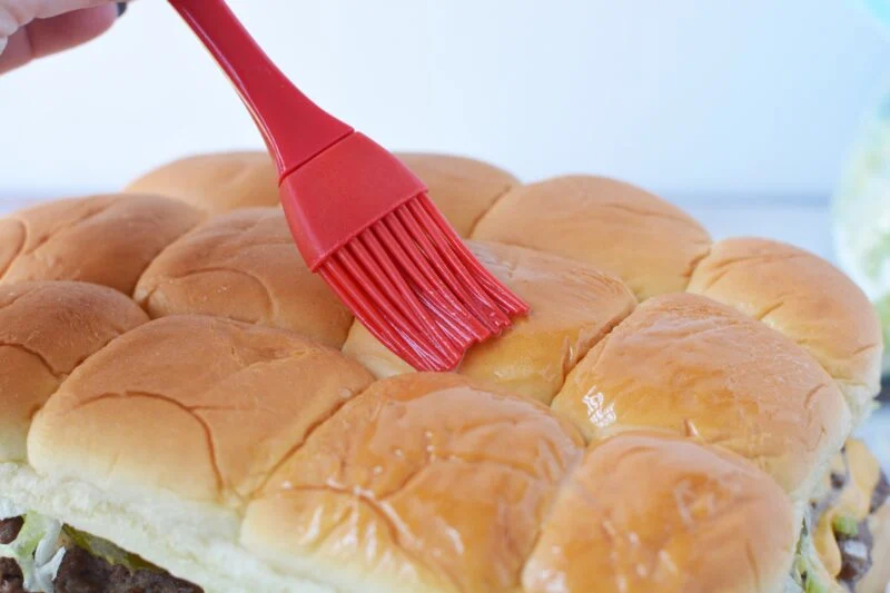 Adding the topping to the burgers
