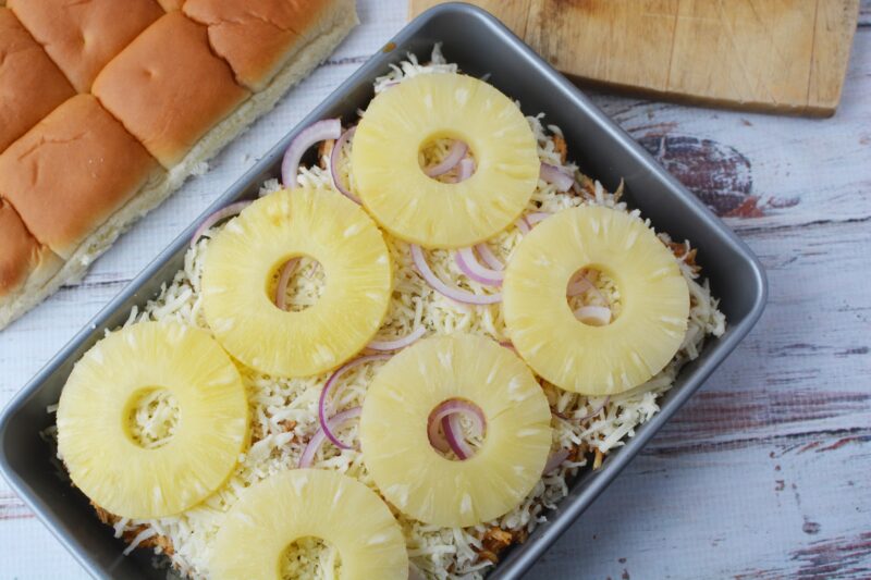 Adding the toppings to the Hawaiian Chicken Sliders
