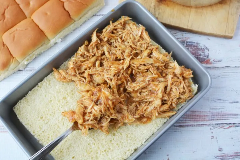 Spreading the chicken over the rolls