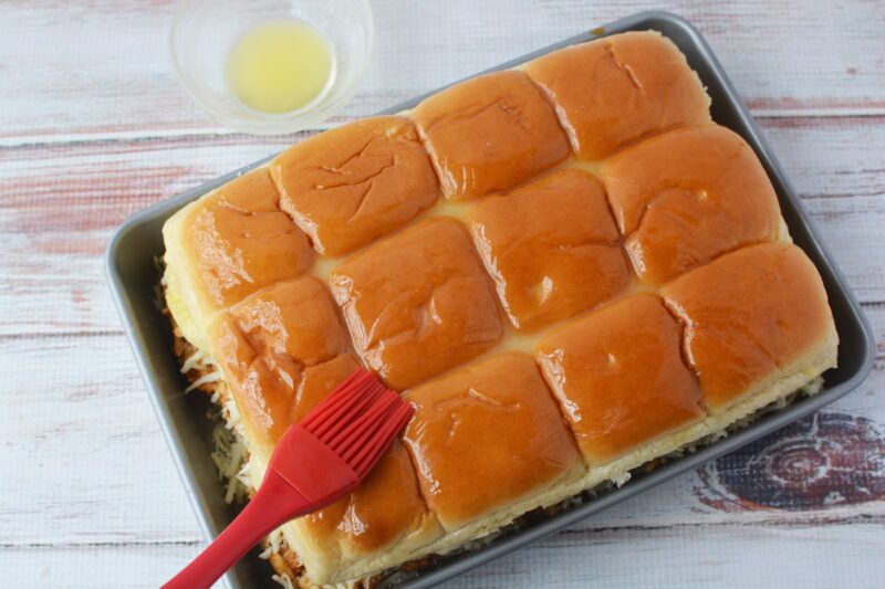 Brushing the top of rolls with melted butter