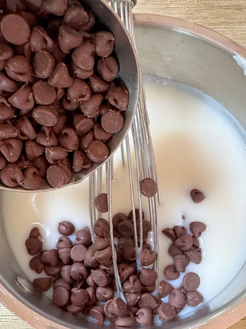 Adding chocolate chips to the coconut pudding