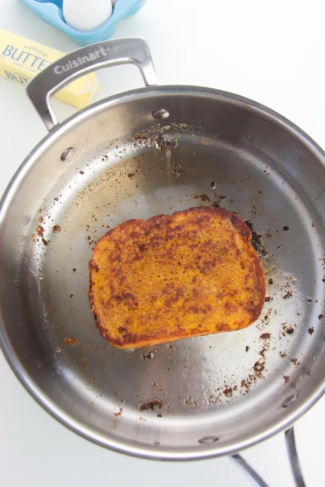 Cooking the pumpkin French toast in a skillet