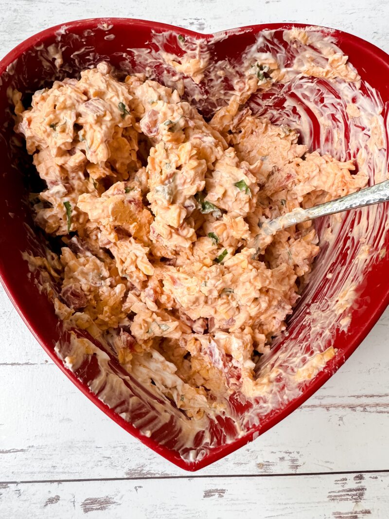 Adding all of the boat dip ingredients in a bowl