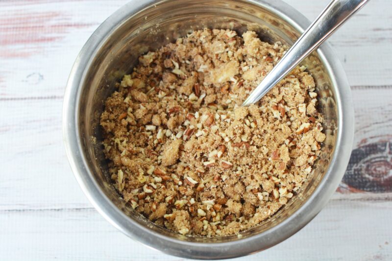 Stirring in the pecans to the butter and flour mixture.