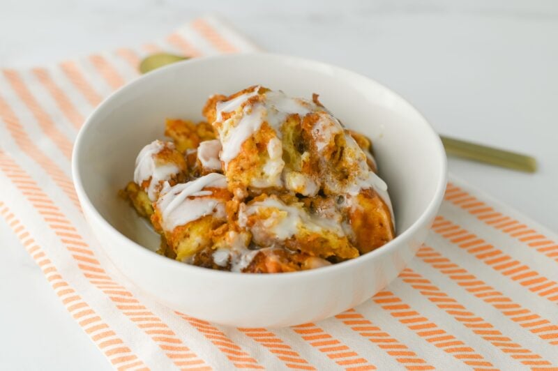 Pumpkin Cinnamon Roll Breakfast Casserole in a white bowl.