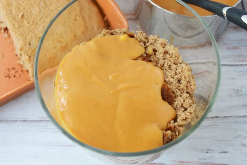 Adding the pumpkin filling on top of the cake mixture