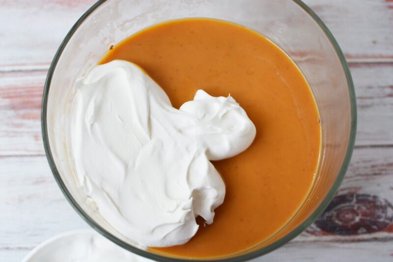 Adding the Cool Whip over the pumpkin layer