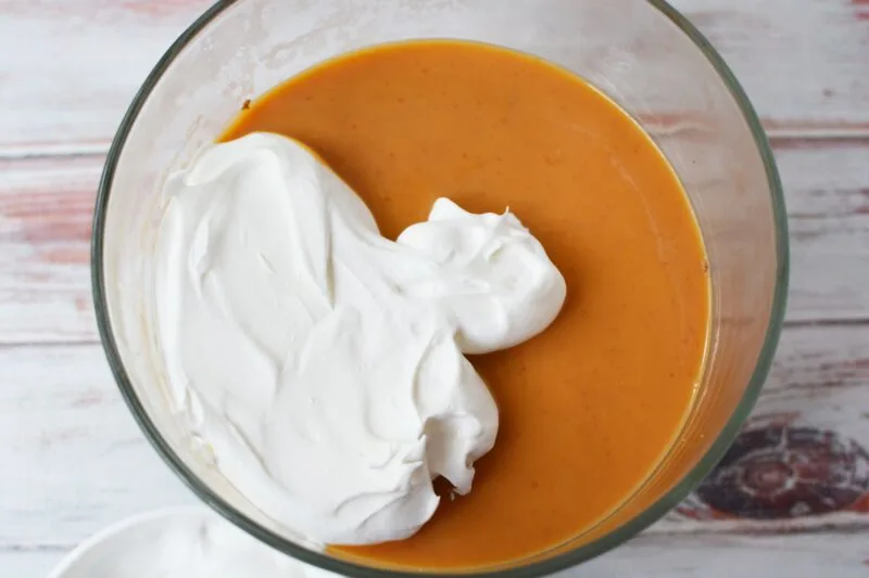 Adding the Cool Whip over the pumpkin layer