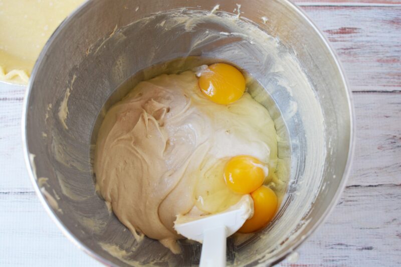 Adding the eggs to the brown sugar and cream cheese mixture