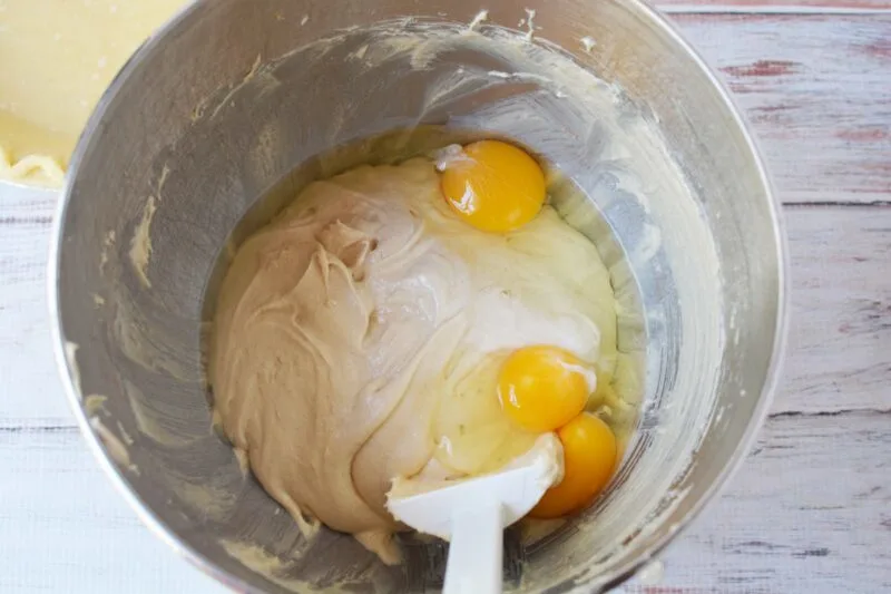 Adding the eggs to the brown sugar and cream cheese mixture