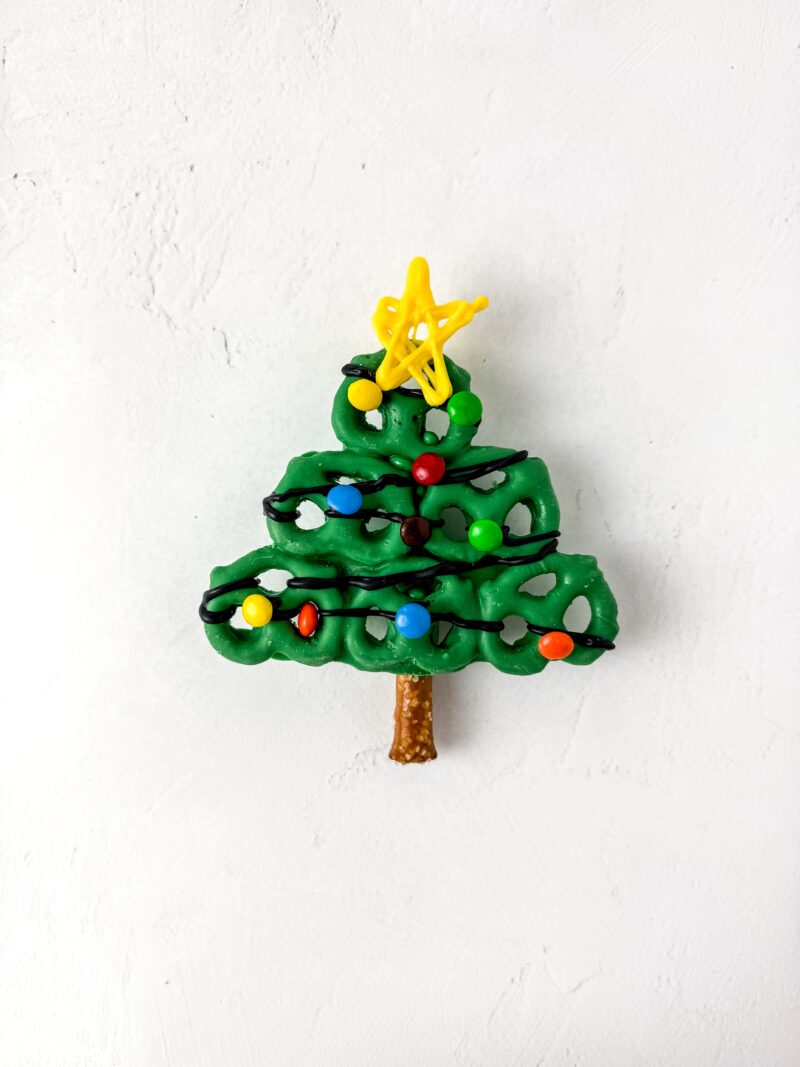 Finishing the Christmas tree by adding the yellow star