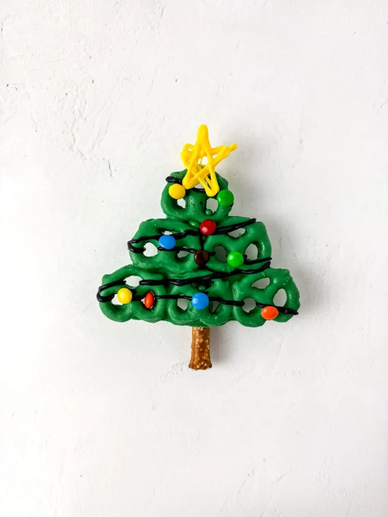 Finishing the Christmas tree by adding the yellow star