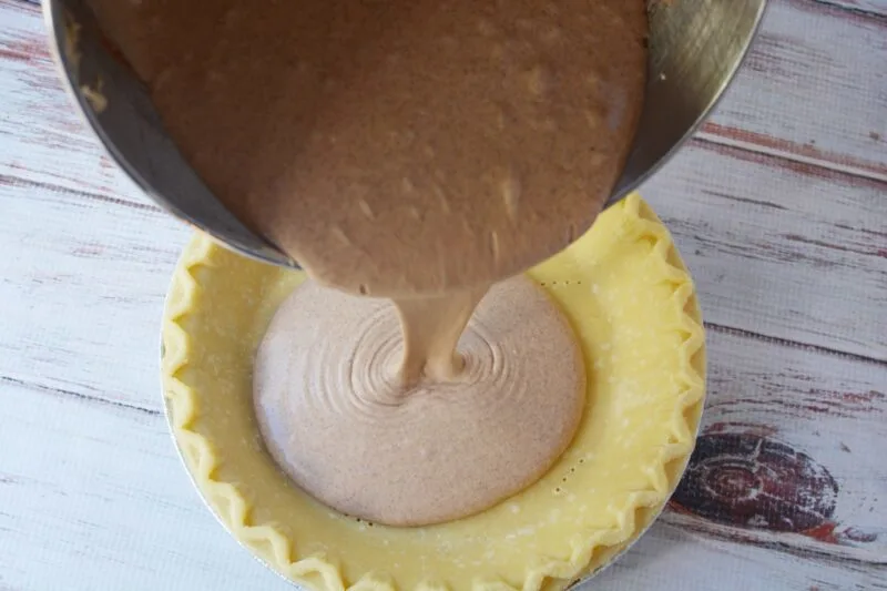 Pouring the cinnamon custard into the pie crust