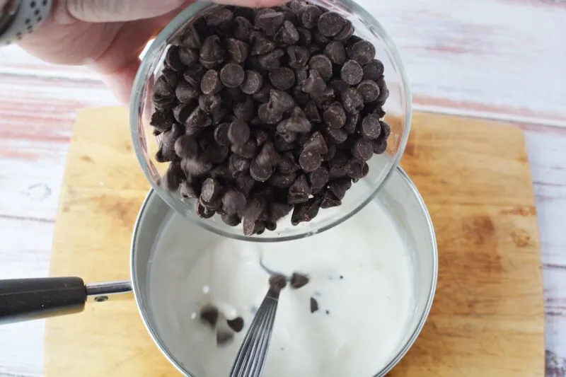 Adding chocolate chips to the ganache