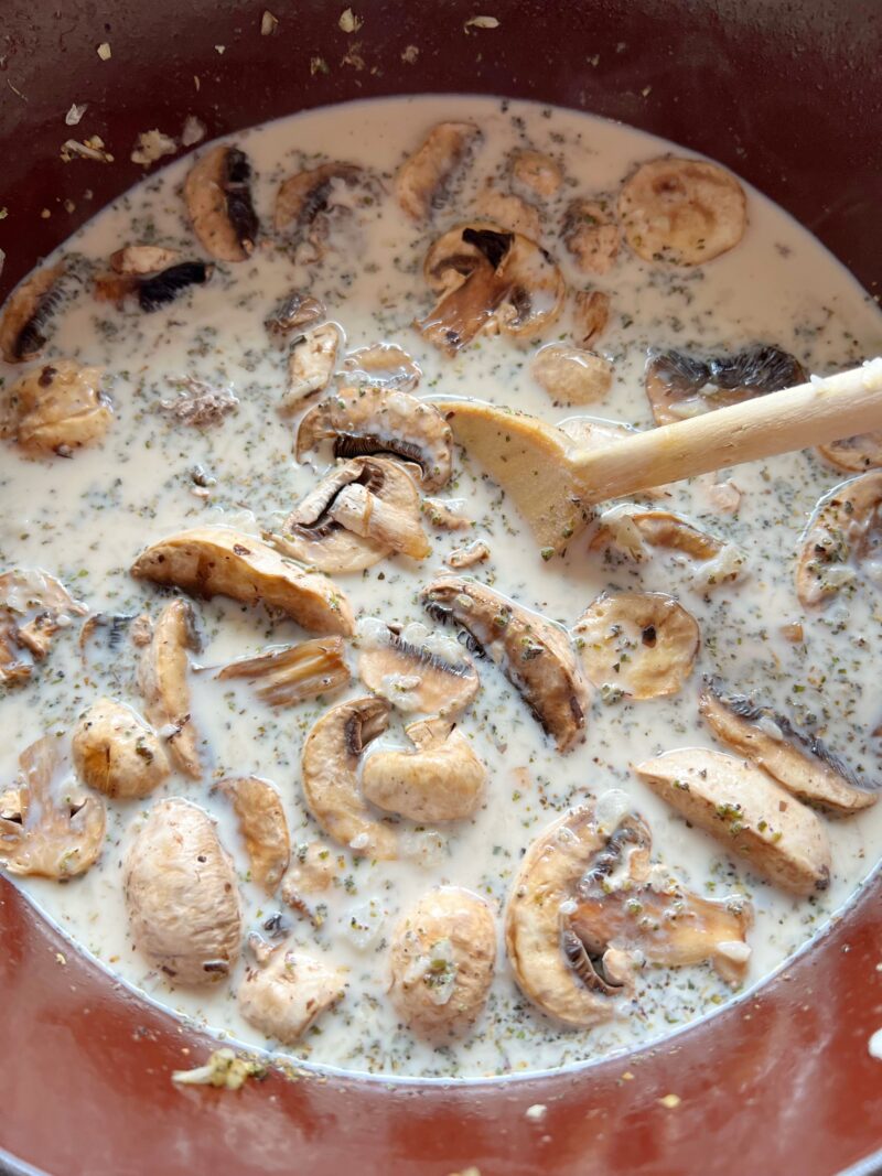 Adding the broth and mushrooms