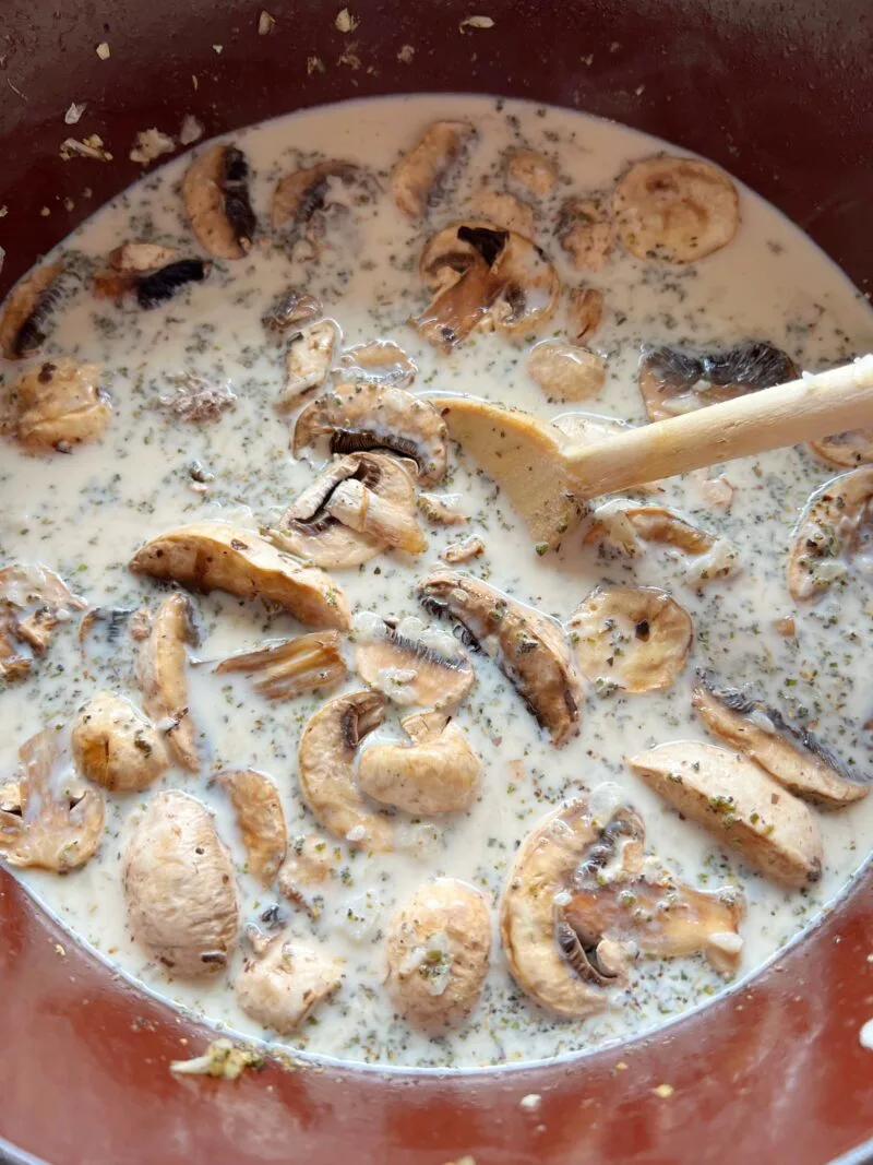 Adding the broth and mushrooms