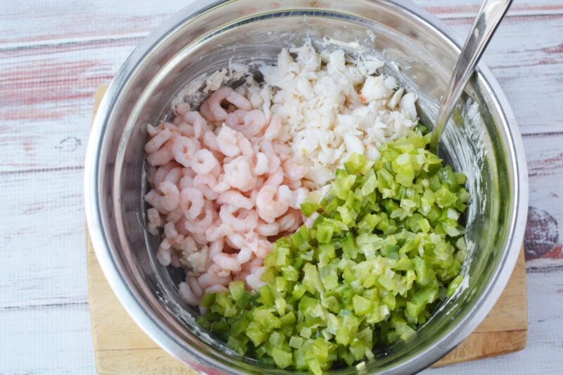 Stirring in the seafood and vegetables to the dip