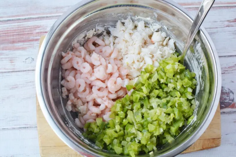 Stirring in the seafood and vegetables to the dip