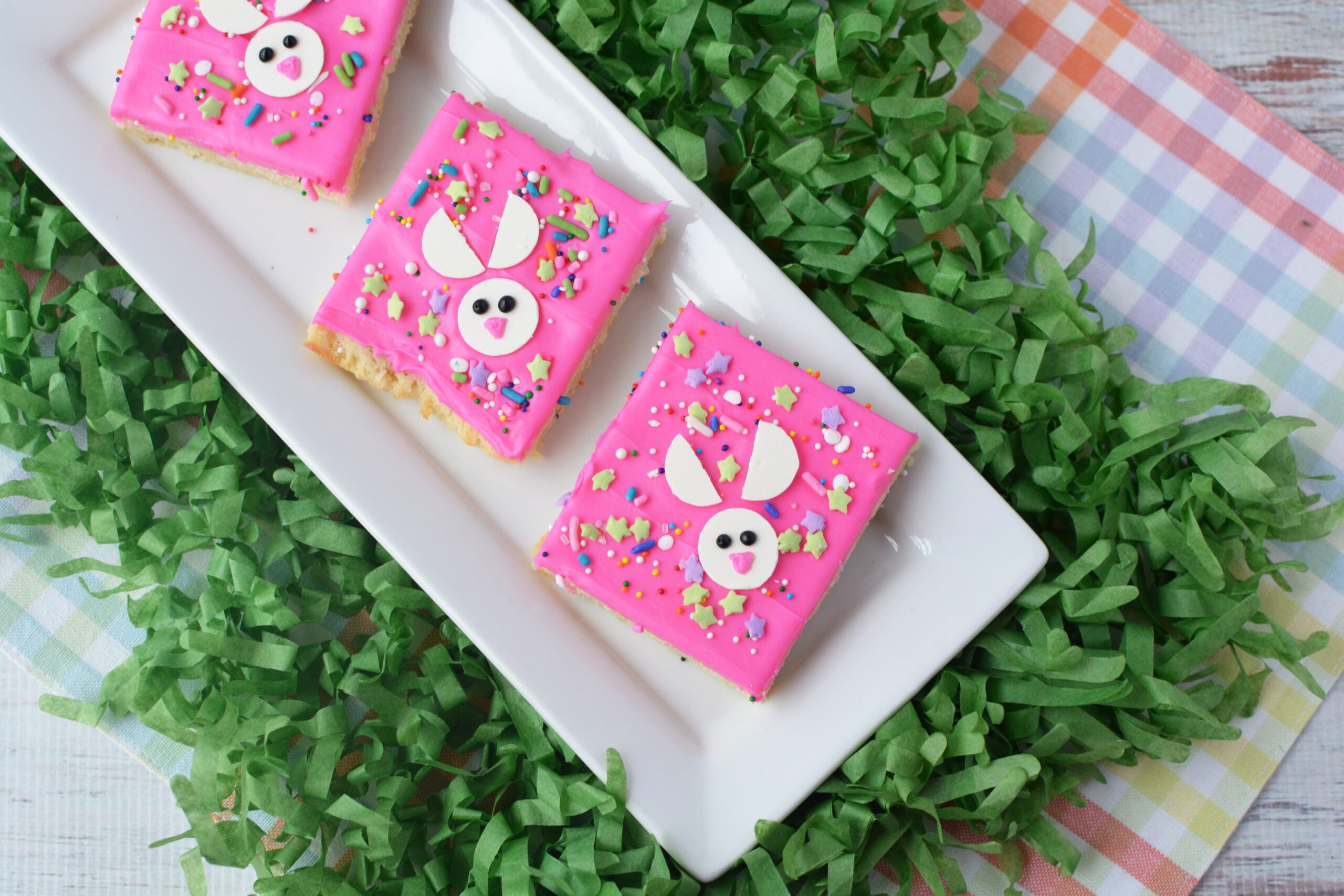 cookie bars with pink icing and easter sprinkles