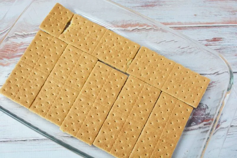 Spreading out the bottom graham cracker layer