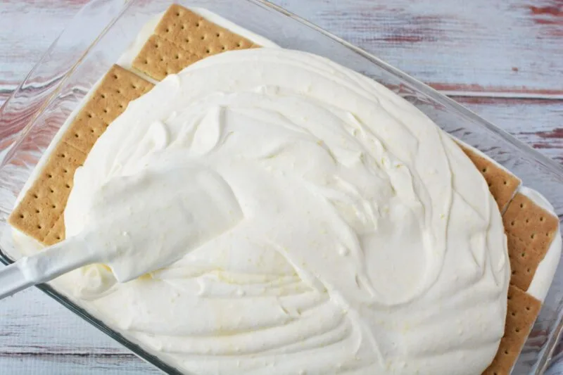 Adding the graham cracker layer and whipped topping