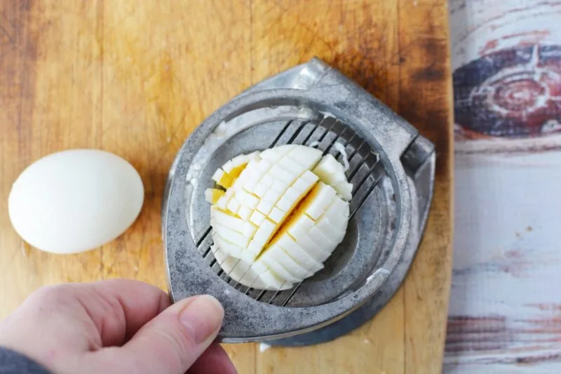 Using the egg slicer to make little pieces of the egg