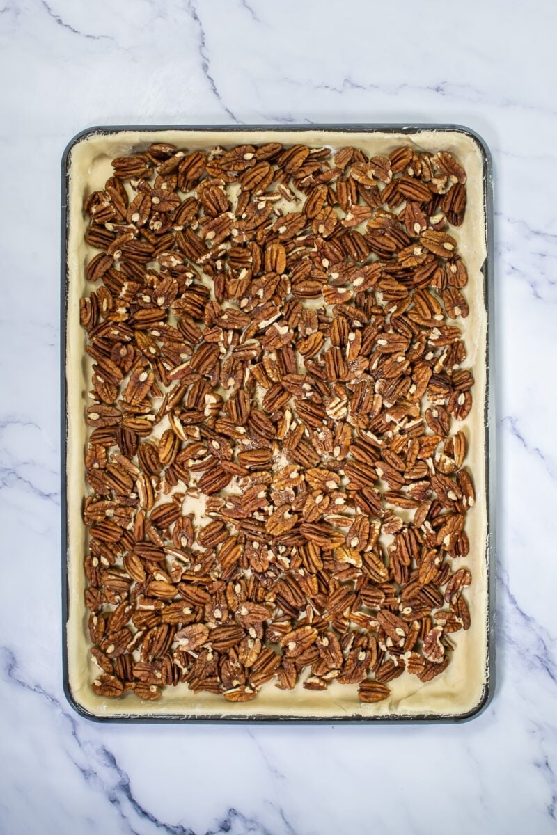 Spreading the pecans on the sheet