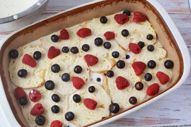 Adding the first layer of berries on top of the custard