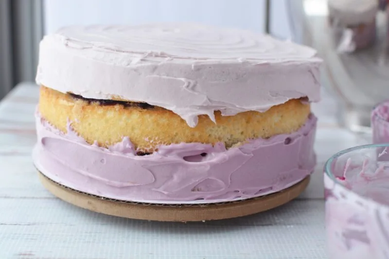 Frosting the bottom of the cake with the darkest frosting layer
