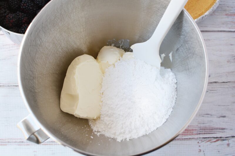 Beating the cream cheese and the powdered sugar together