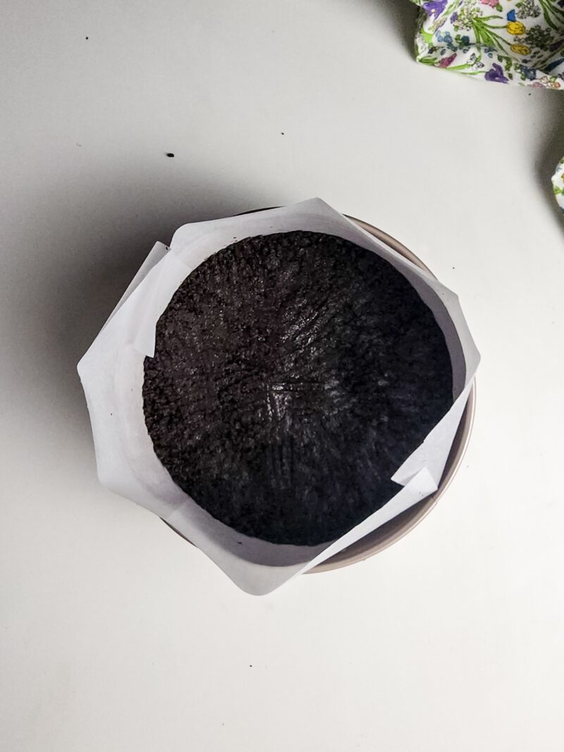 Pressing the cookie crust into bottom of pan